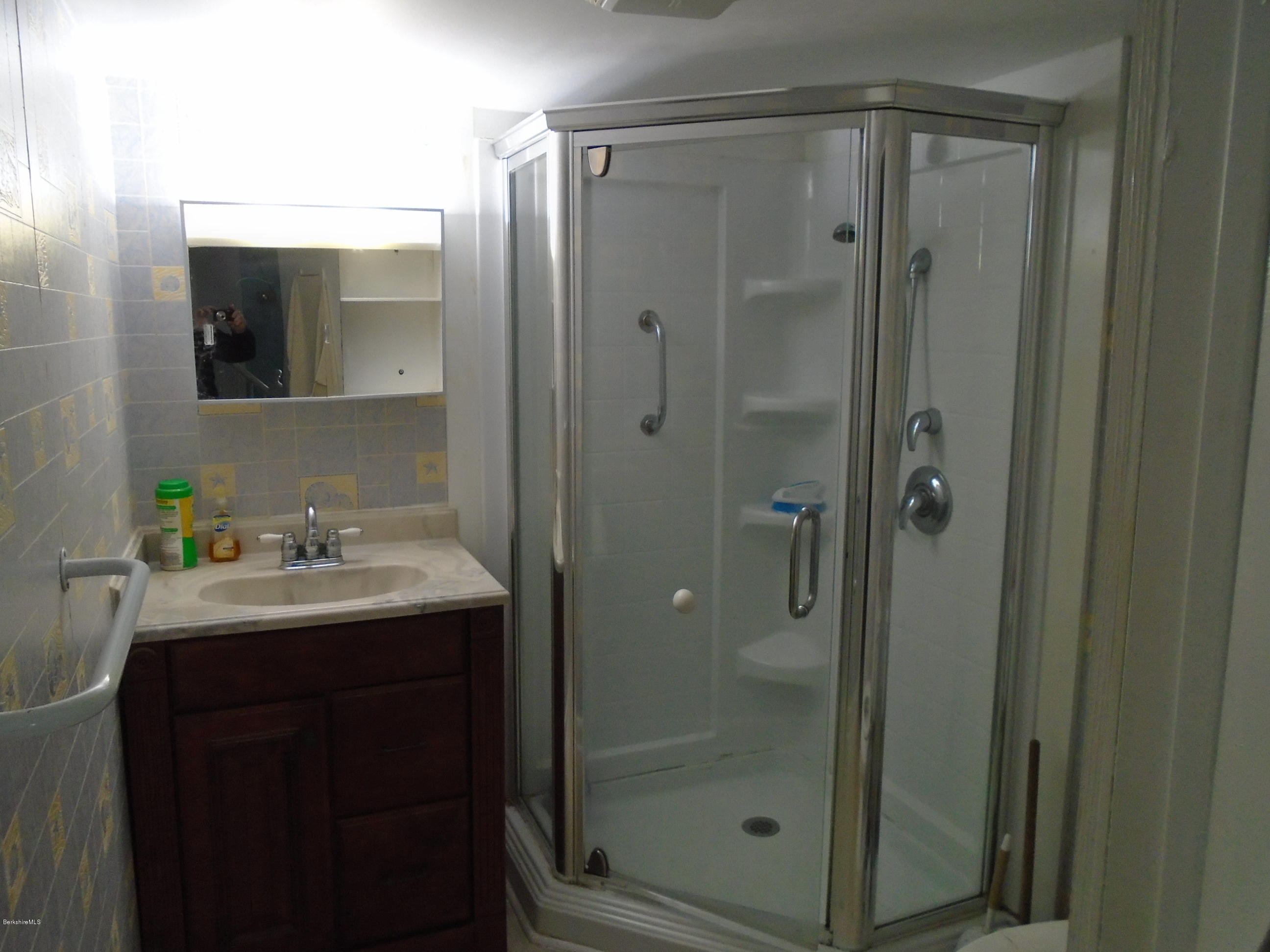 131 Main Road Tyringham, MA 01264 - Photo 5 of 5 a bathroom with a shower sink and mirror