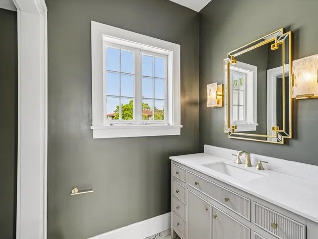a bathroom with a sink a mirror and shower