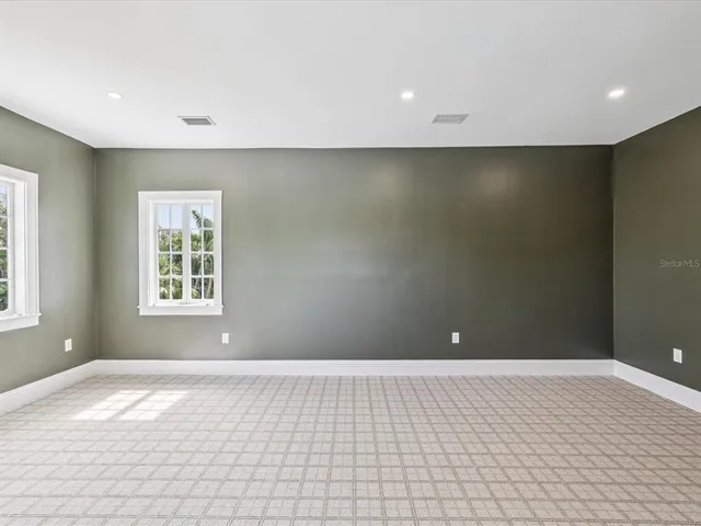 a bathroom with a granite countertop toilet sink and mirror