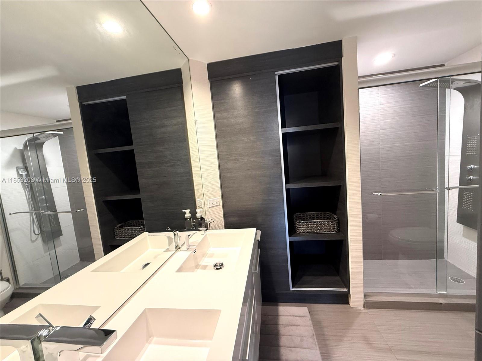 801 Brickell Key Boulevard, Unit 2402 Miami, FL 33131 - Photo 14 of 37 a bathroom with a bathtub and a shower