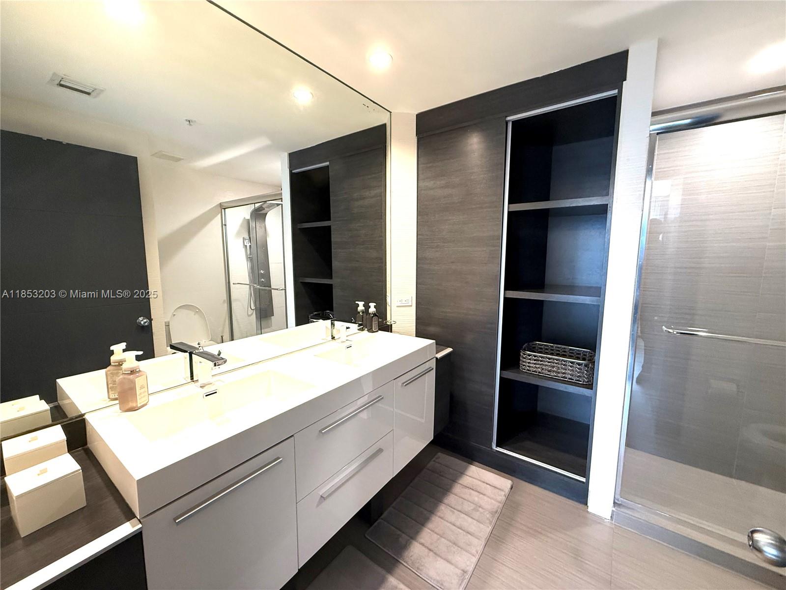 801 Brickell Key Boulevard, Unit 2402 Miami, FL 33131 - Photo 15 of 37 a bathroom with a sink and a mirror
