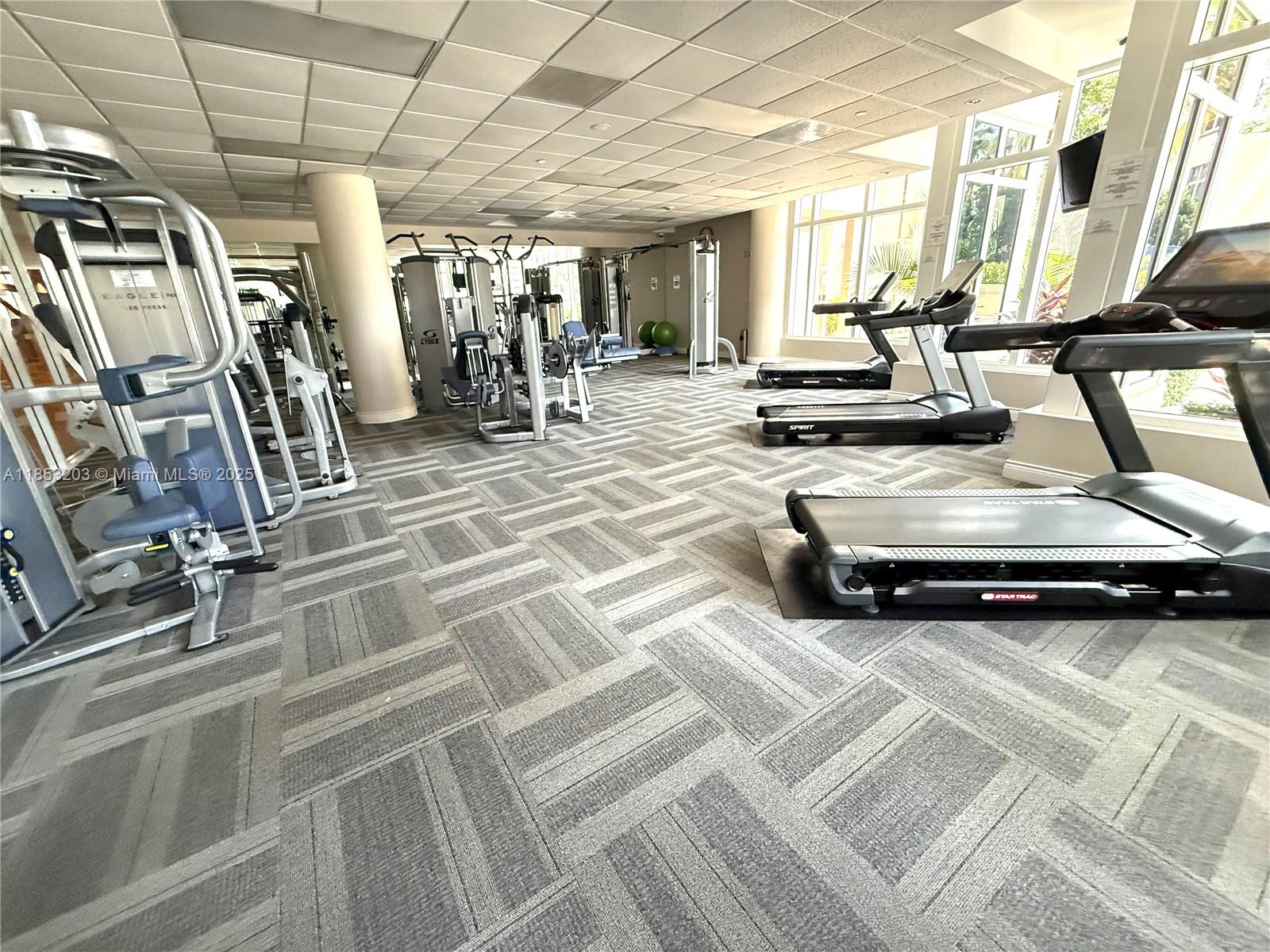 801 Brickell Key Boulevard, Unit 2402 Miami, FL 33131 - Photo 25 of 37 a view of a room with gym equipment