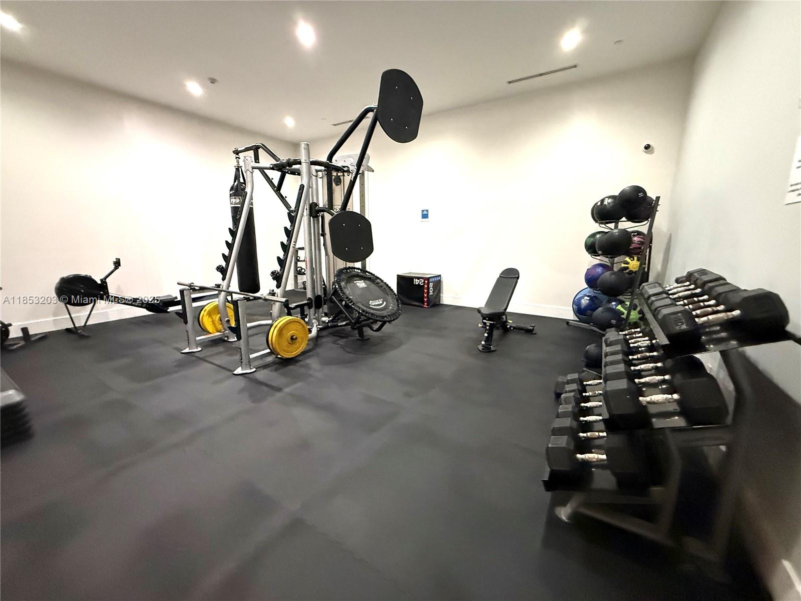 801 Brickell Key Boulevard, Unit 2402 Miami, FL 33131 - Photo 27 of 37 a gym room with gym equipment