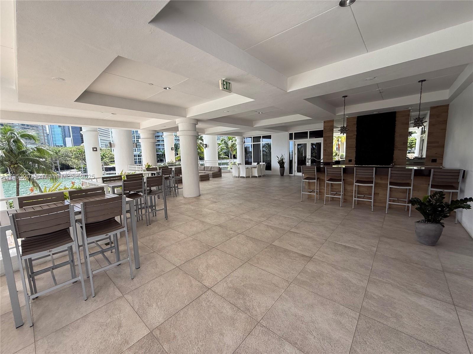 801 Brickell Key Boulevard, Unit 2402 Miami, FL 33131 - Photo 30 of 37 a room with lots of tables a dining table and chairs