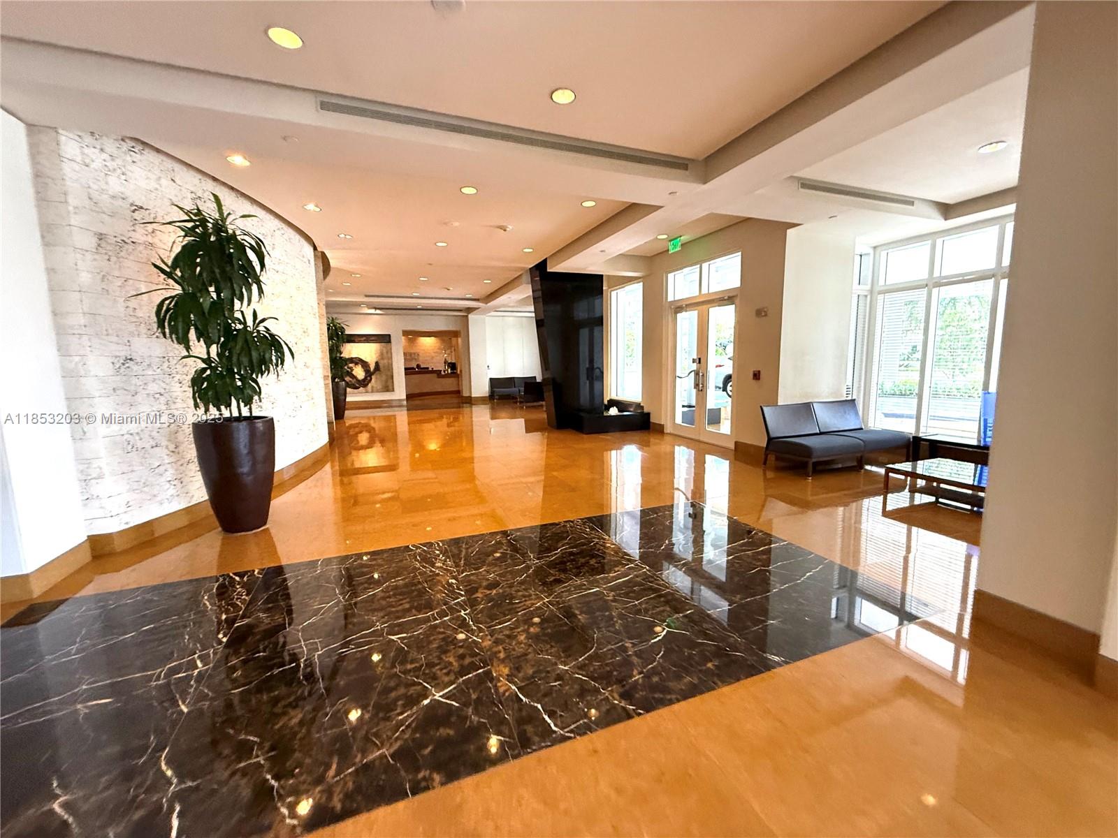801 Brickell Key Boulevard, Unit 2402 Miami, FL 33131 - Photo 33 of 37 a lobby with furniture and floor to ceiling window