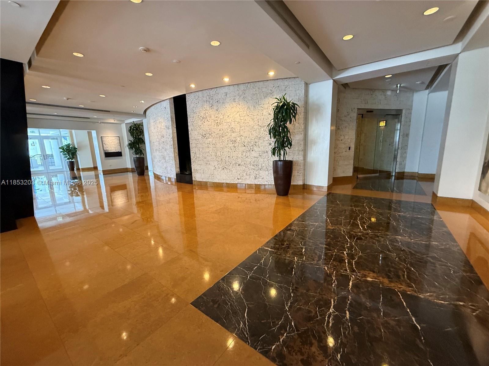 801 Brickell Key Boulevard, Unit 2402 Miami, FL 33131 - Photo 34 of 37 a view of a lobby with black carpet