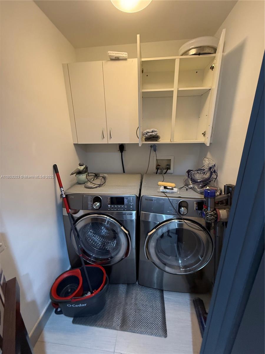 801 Brickell Key Boulevard, Unit 2402 Miami, FL 33131 - Photo 37 of 37 a kitchen with a sink a stove and a wooden floor