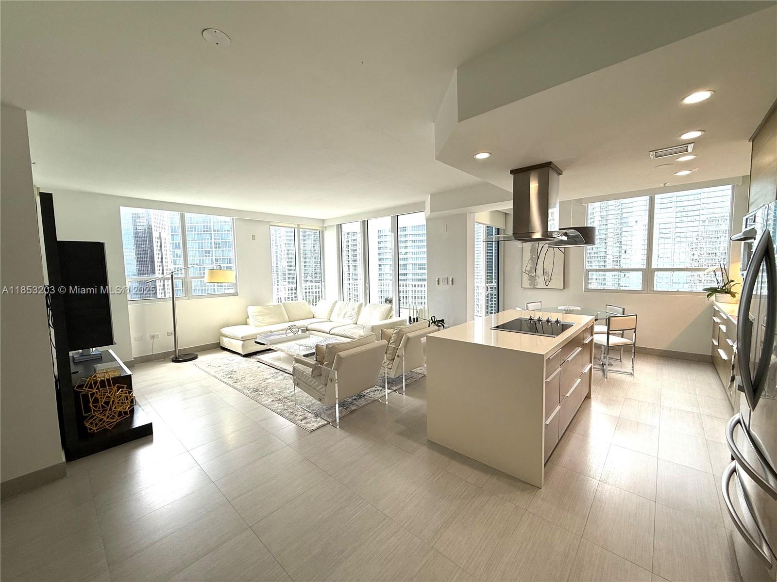 801 Brickell Key Boulevard, Unit 2402 Miami, FL 33131 - Photo 5 of 37 a living room with furniture and a flat screen tv