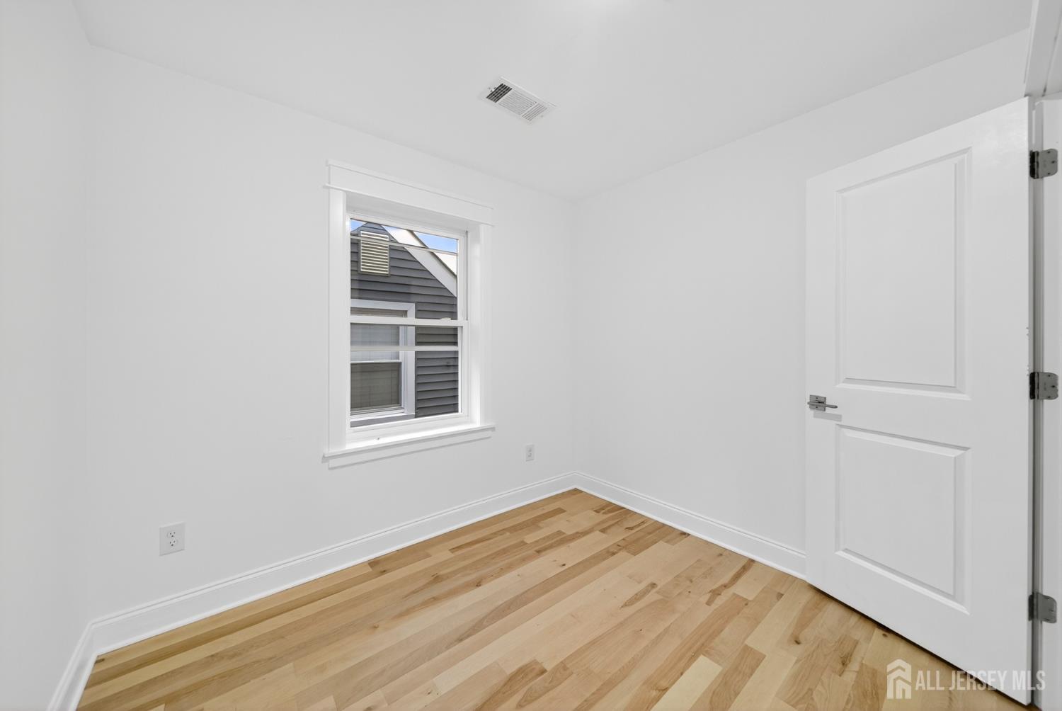 720 Donald Avenue Perth Amboy, NJ 08861 - Photo 20 of 33 a view of empty room with wooden floor and fan