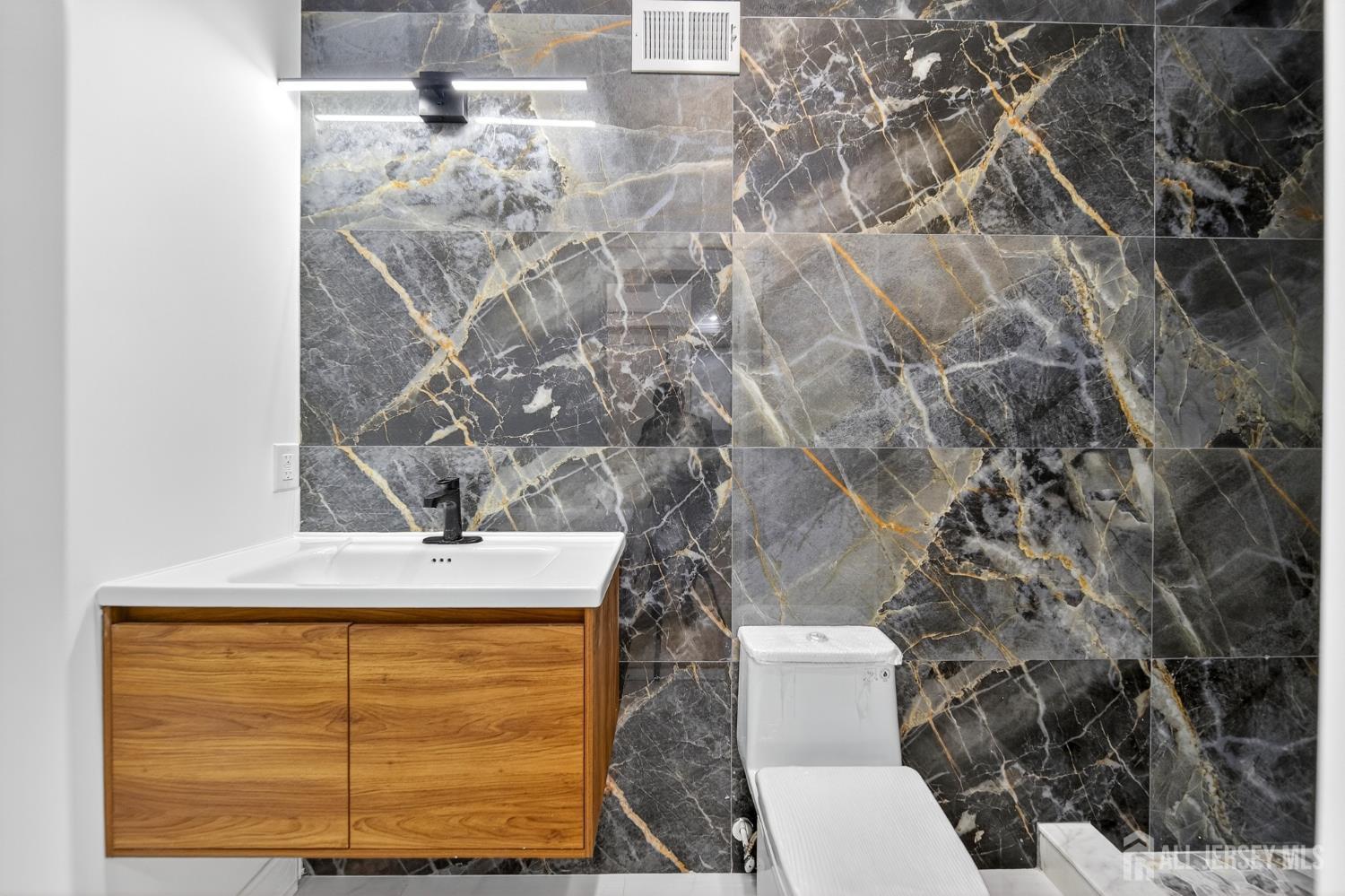 720 Donald Avenue Perth Amboy, NJ 08861 - Photo 10 of 33 a bathroom with a toilet and sink