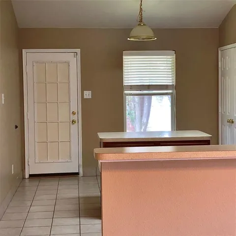 a view of a kitchen with a sink cabinet and a window