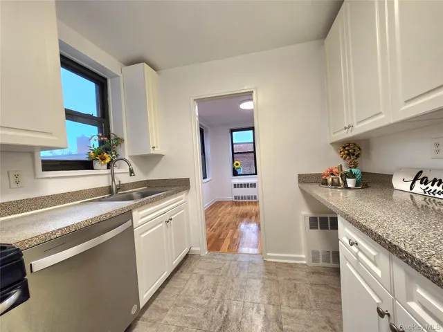 a kitchen with stainless steel appliances granite countertop a sink and cabinets