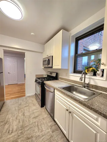 a kitchen with stainless steel appliances granite countertop a sink and cabinets