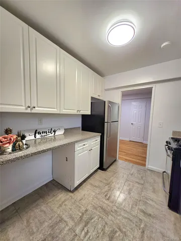 a kitchen with stainless steel appliances granite countertop a refrigerator and a stove
