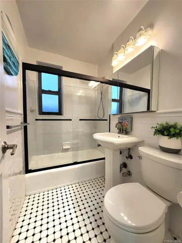 a bathroom with a sink a toilet a mirror and vanity
