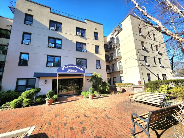 a front view of a building and car parked