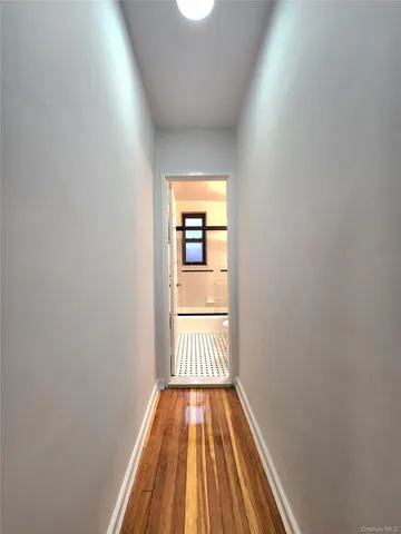 a view of a room with wooden floor and door