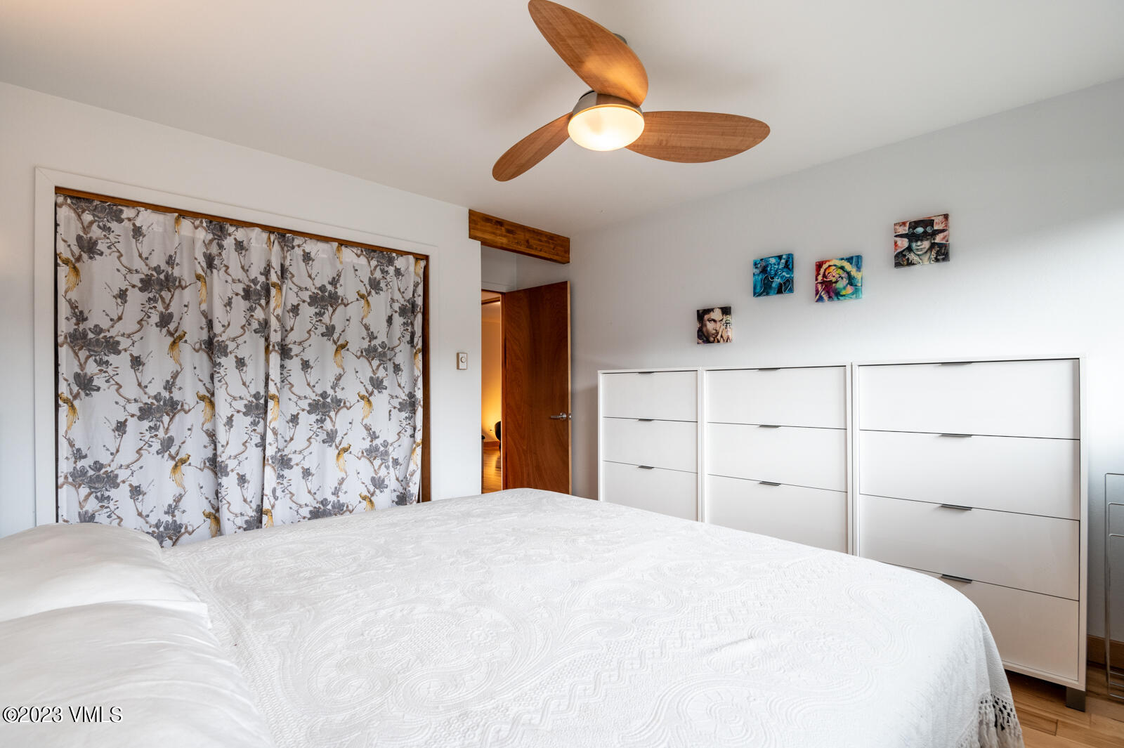 211 Nottingham Road, Unit D Avon, CO 81620 - Photo 16 of 35 a bedroom with a large bed and a chandelier