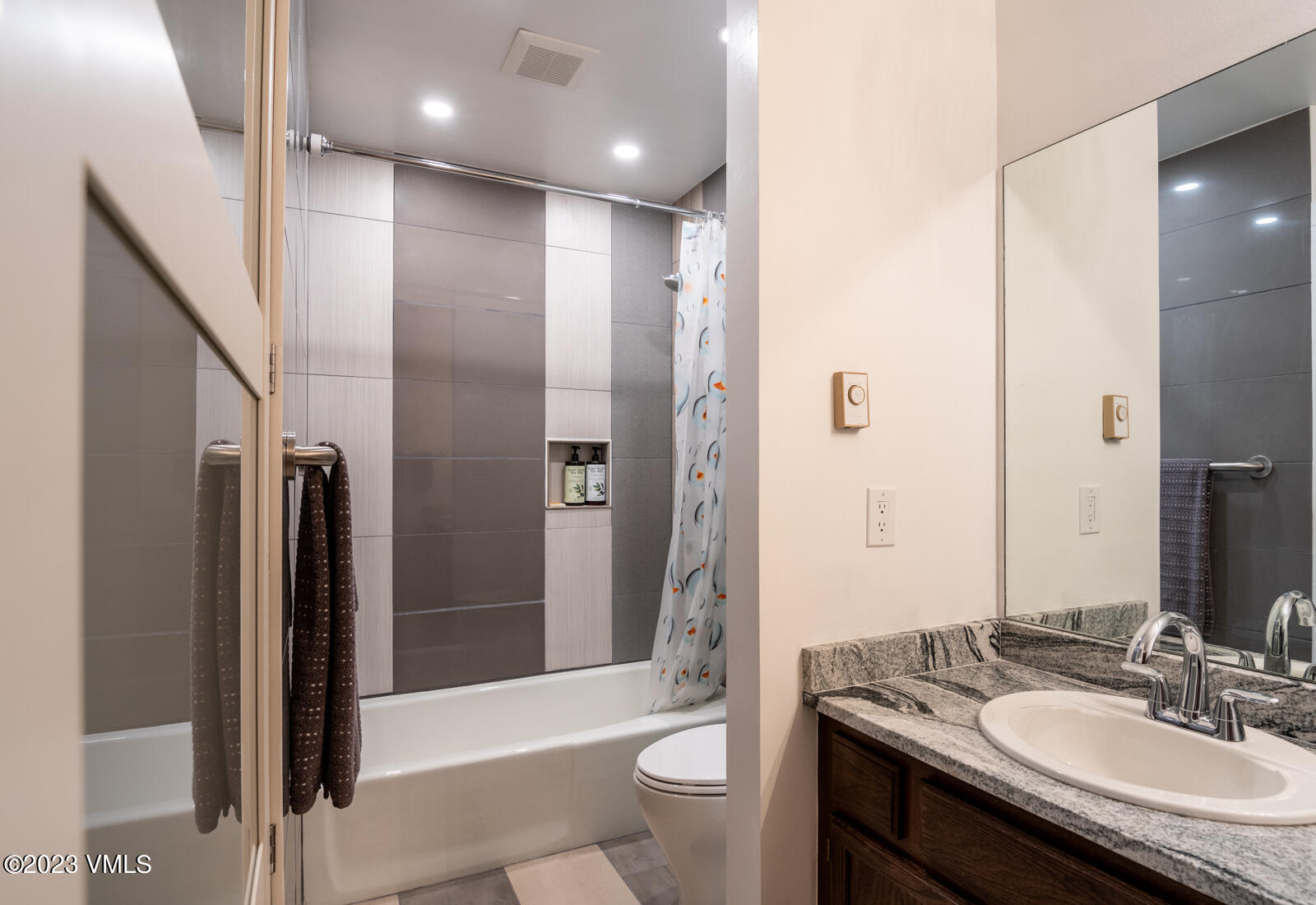211 Nottingham Road, Unit D Avon, CO 81620 - Photo 22 of 35 a bathroom with a granite countertop sink a toilet a mirror and shower