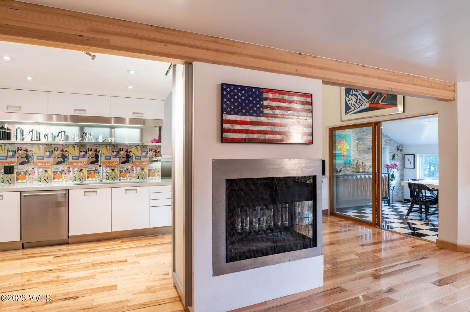 211 Nottingham Road, Unit D Avon, CO 81620 - Photo 10 of 35 a open kitchen view with a fireplace and wooden floor