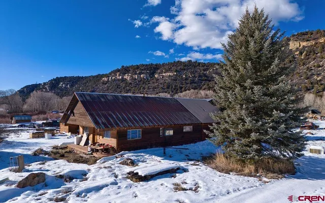 a view of house with backyard space and balcony