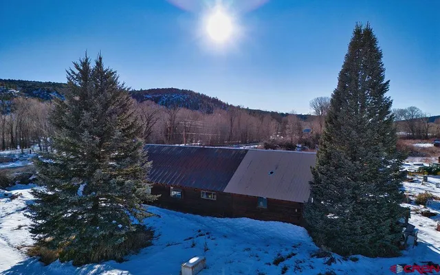 a view of a house with a yard and tree s