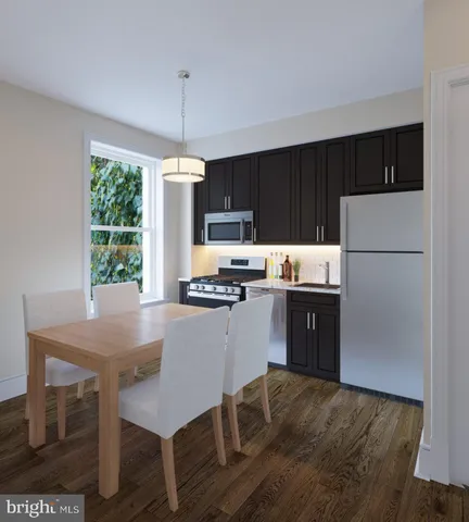 a kitchen with kitchen island a stove a sink dishwasher a refrigerator with a dining table and chairs