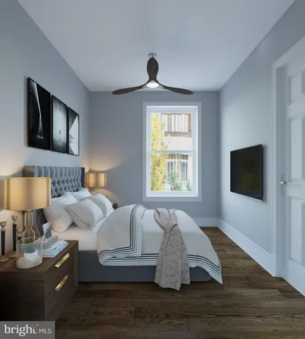 a living room with a bed furniture and a flat screen tv