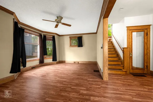 a view of entryway and hall with wooden floor