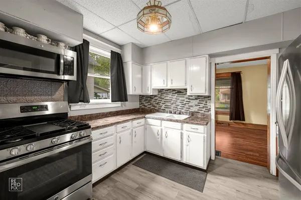 a kitchen with stainless steel appliances granite countertop a stove and a sink