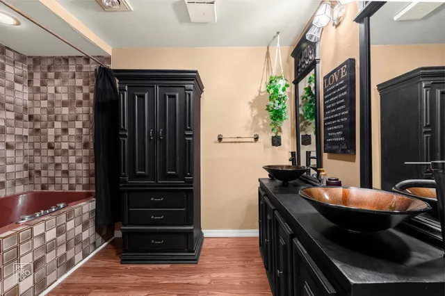 a bathroom with a sink a mirror and a shower