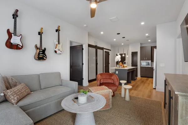 a living room with furniture and kitchen view
