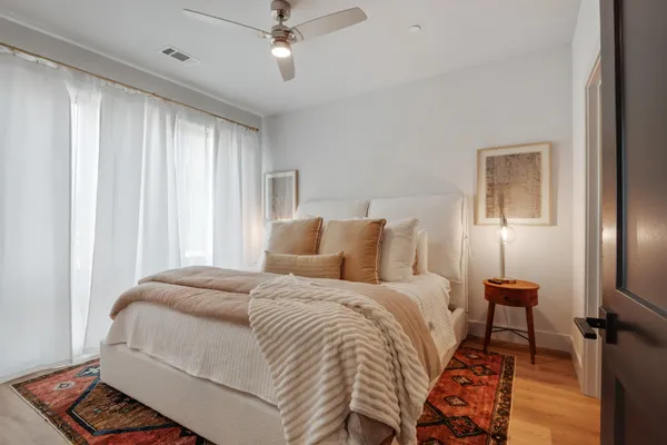 a bedroom with a bed and a lamp