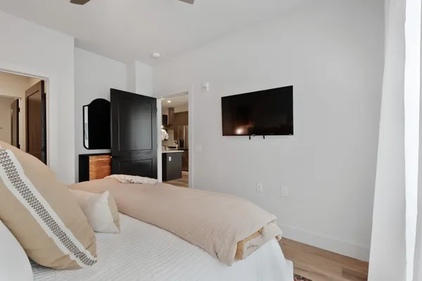 a bedroom with a bed and a flat screen tv
