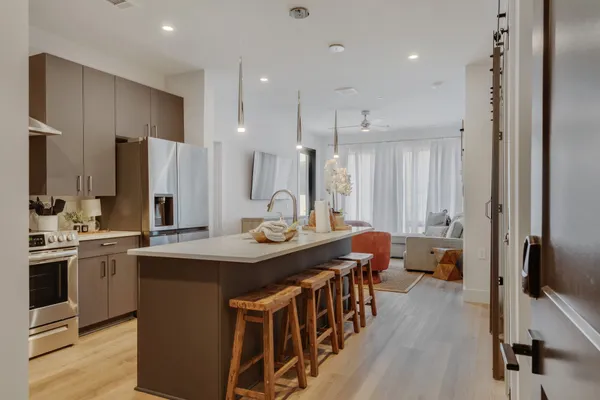 a large kitchen with a table and chairs