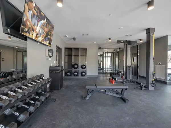 a room with gym equipment and a large window