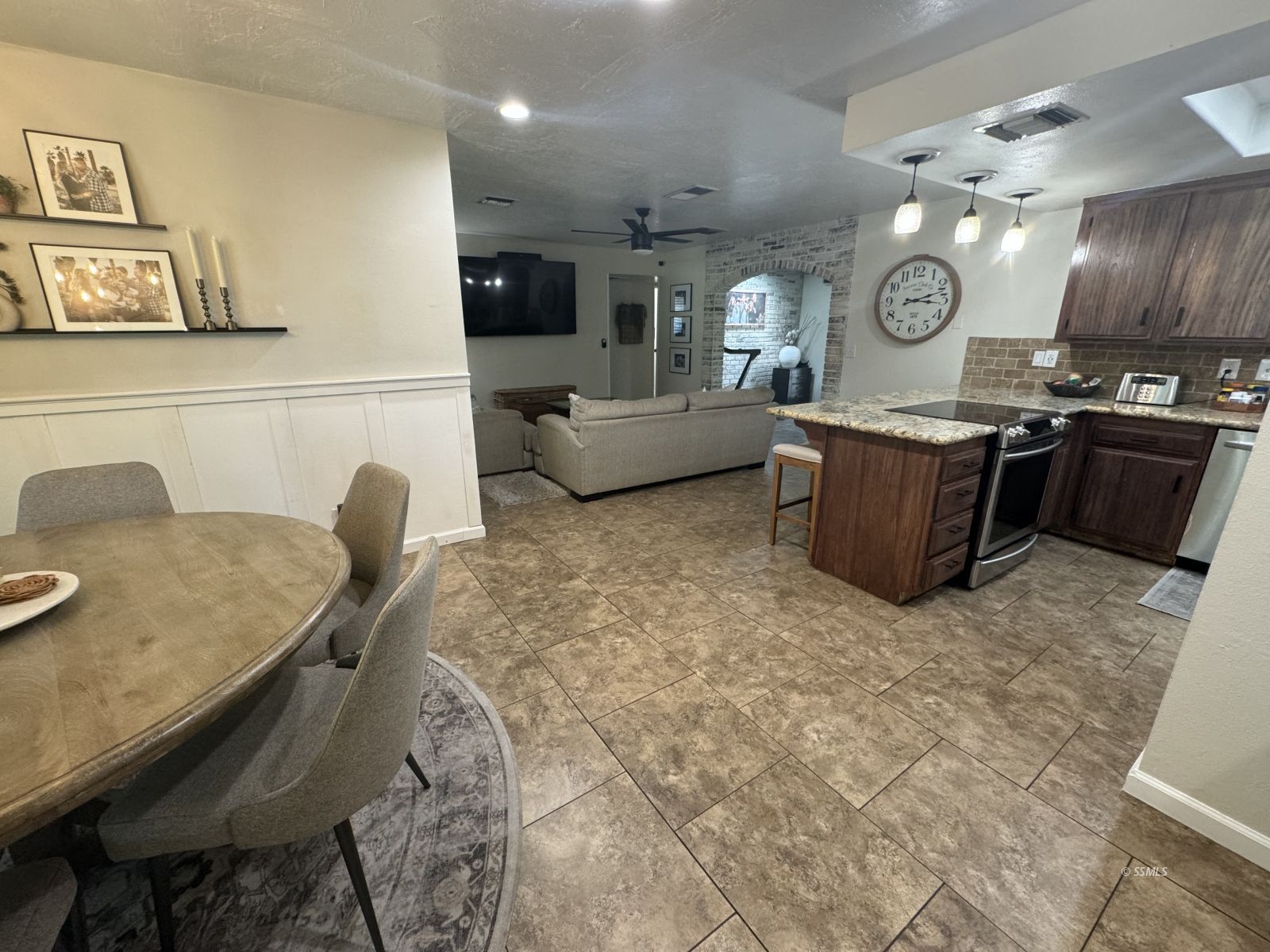 1024 Las Cruces Avenue Ridgecrest, CA 93555 - Photo 7 of 37 a living room with couches and kitchen view with wooden floor