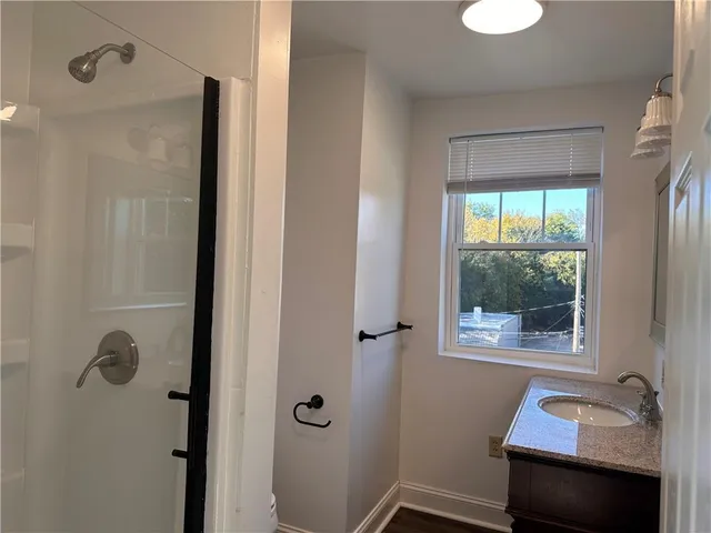 a bathroom with a tub a sink and a window