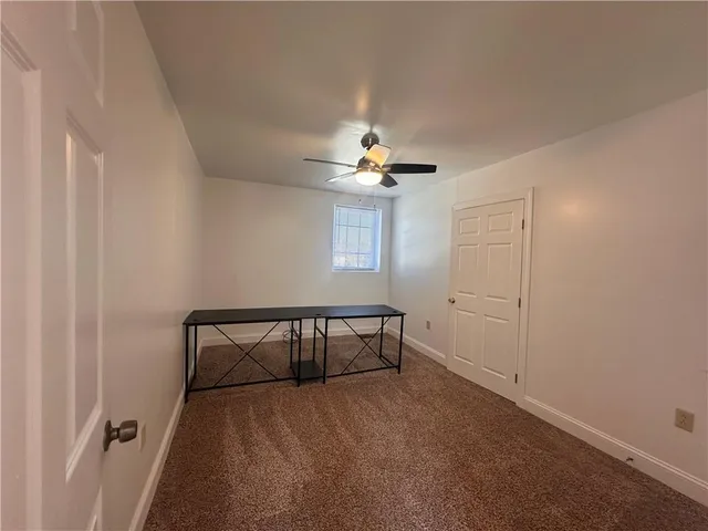 a view of room with a ceiling fan and window