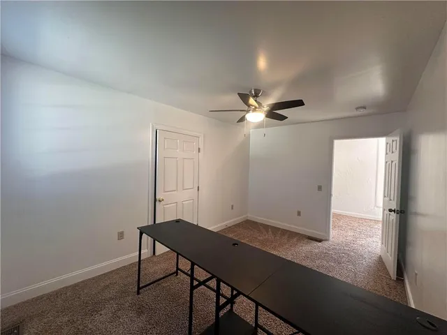 a view of a room with a table and chairs
