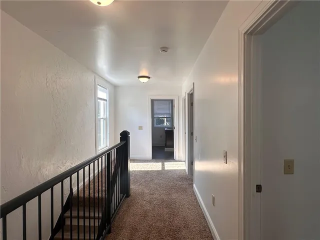 a view of a hallway view with staircase