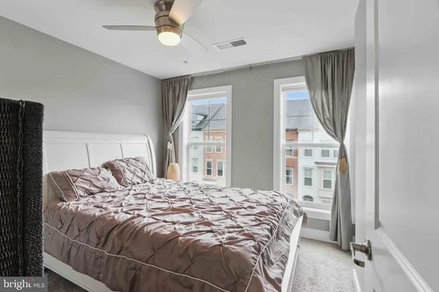 a bedroom with a bed window and a chandelier