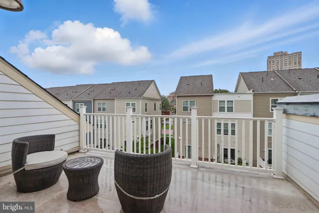 a view of a chair and tables back yard of the house
