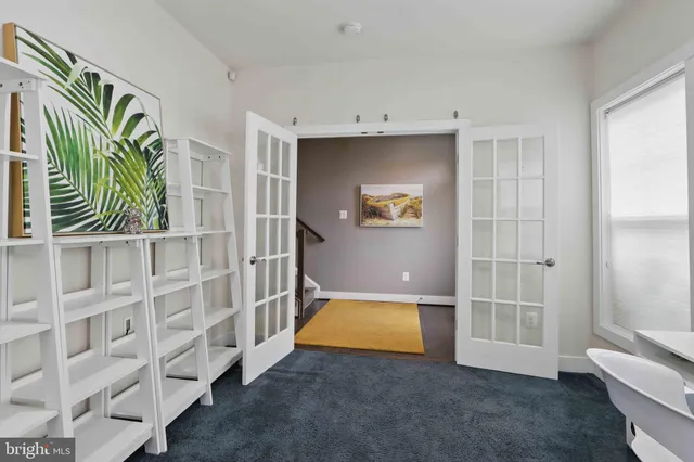 a view of an empty room with a window and staircase