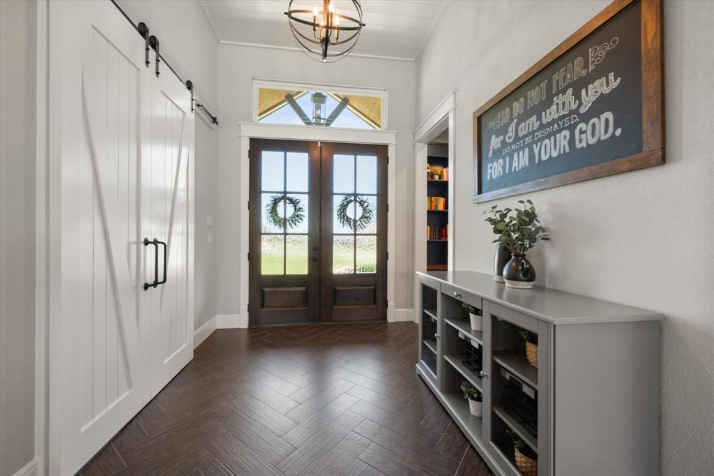 6425 Starlight Ranch Road Godley, TX 76044 - Photo 4 of 37 Wood grain tile from the entrance, through the hall and into the great room, kitchen and dining area. Barn doors close off the bonus room. Study is across the hall.