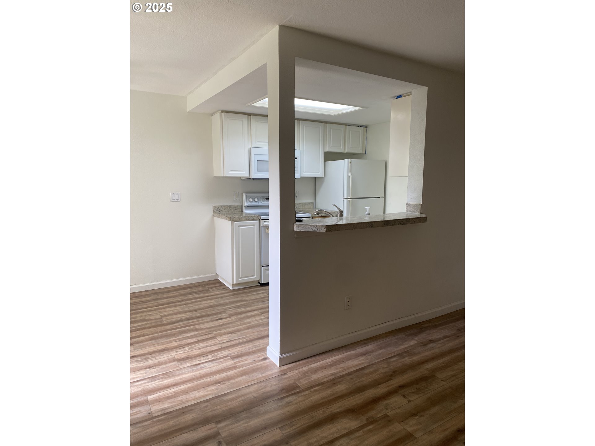 9872 Southeast Talbert Street Clackamas, OR 97015 - Photo 11 of 38 a view of a kitchen cabinets and a wooden floor