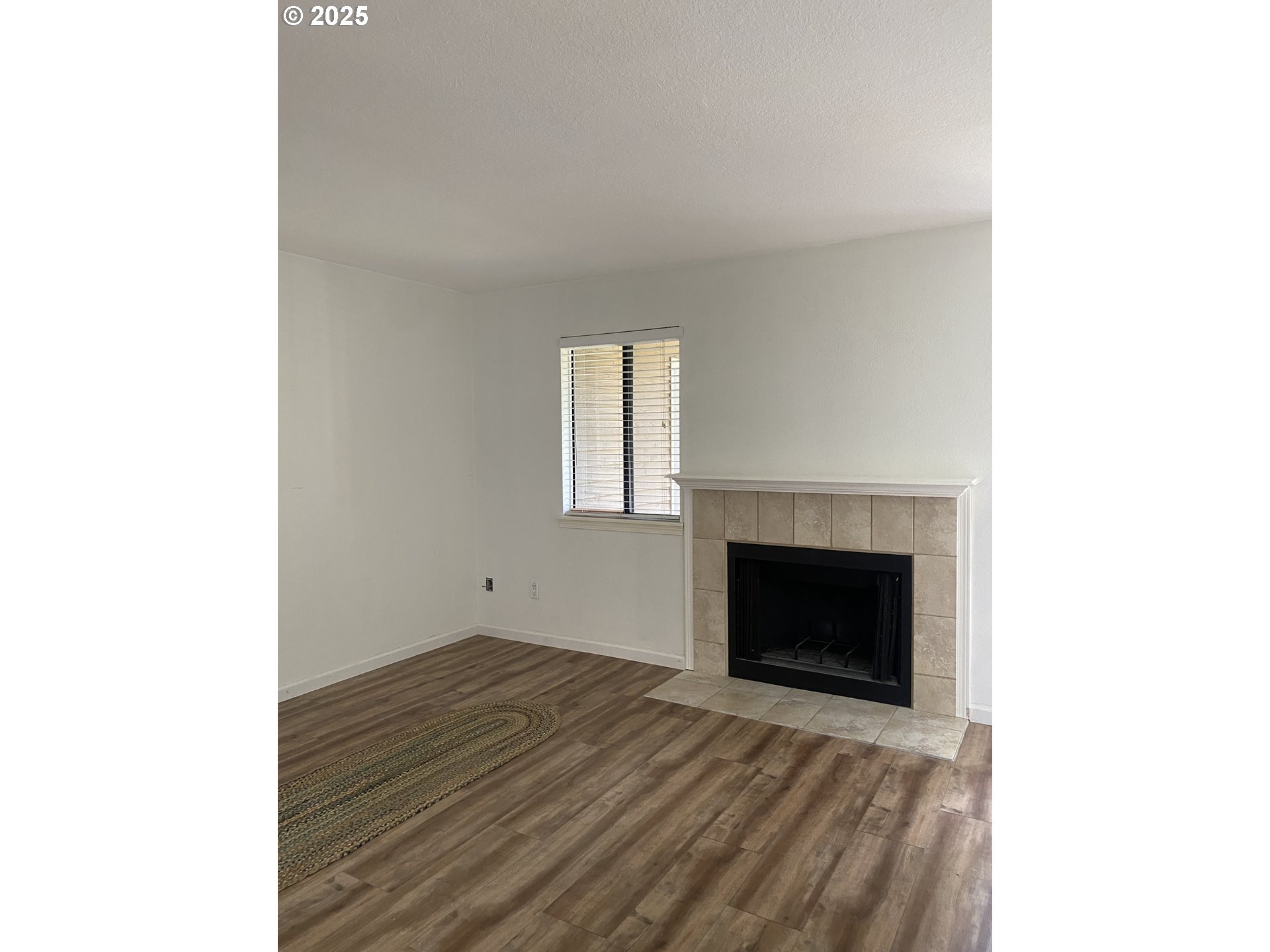 9872 Southeast Talbert Street Clackamas, OR 97015 - Photo 7 of 38 a room with a fireplace and a window