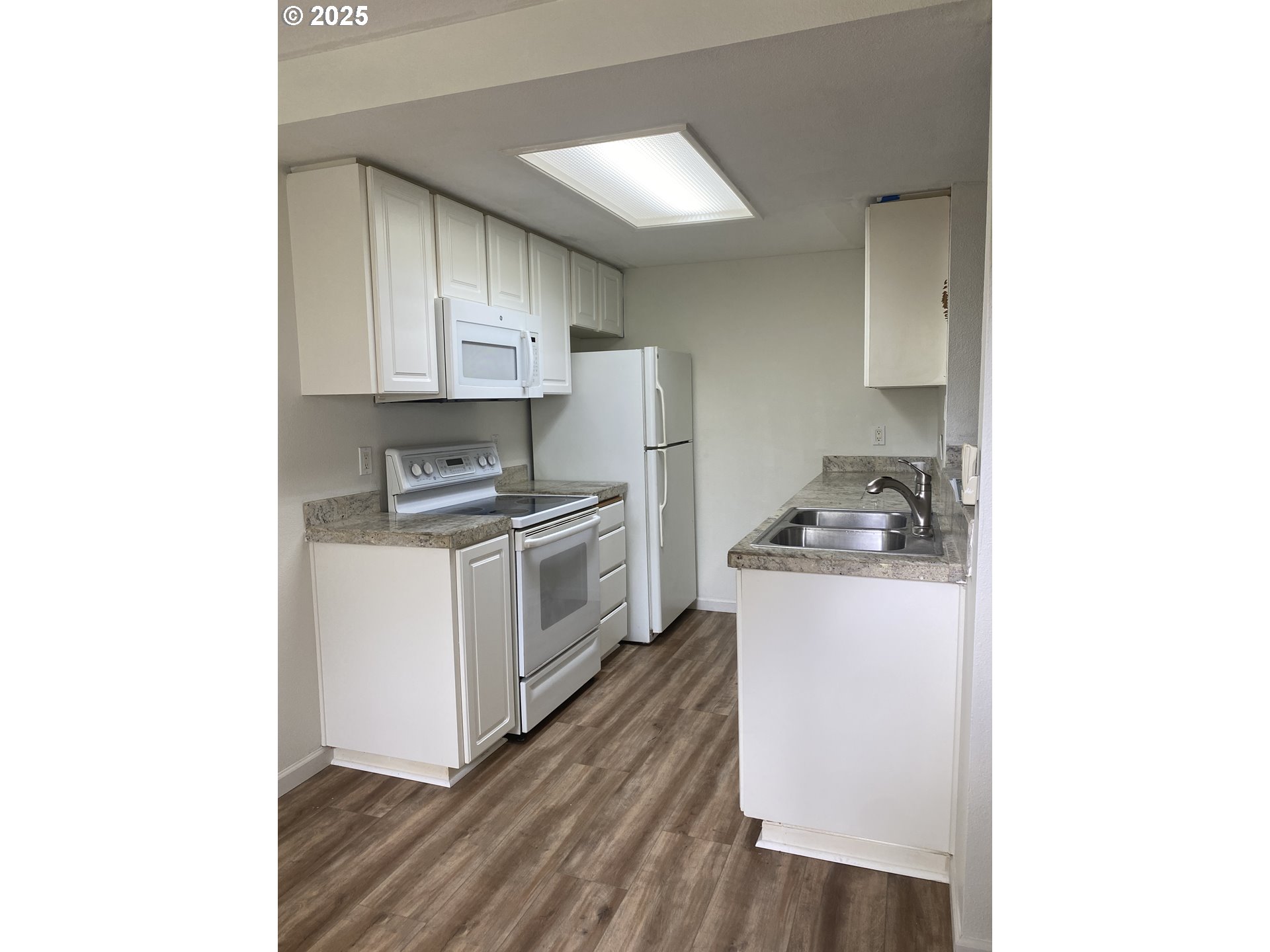 9872 Southeast Talbert Street Clackamas, OR 97015 - Photo 10 of 38 a kitchen with granite countertop white cabinets and white appliances