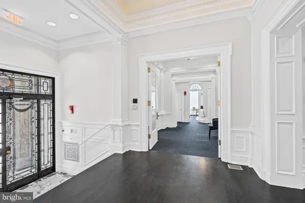 a view of a hallway with wooden floor and closet area