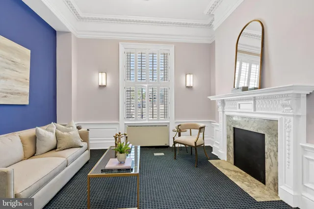 a living room with furniture a fireplace and window